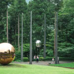 Hakone Open-Air Museum (箱根彫刻の森美術館): A Sculpture Wonderland in Nature Sculptures of reflective silver and gold spheres stand amid tall trees and grass at the Hakone Open-Air Museum, while several people walk nearby in an outdoor park surrounded by greenery.